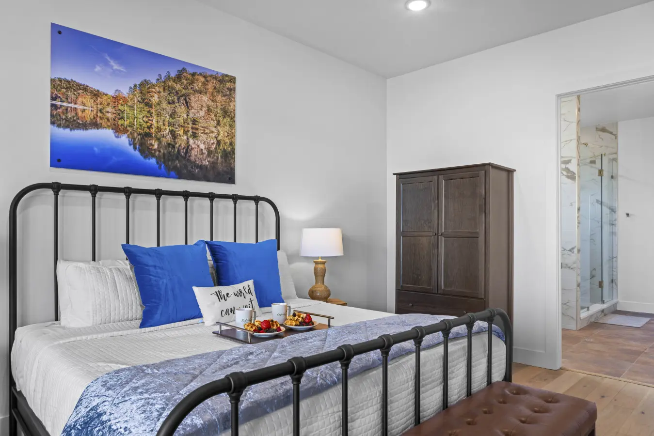 Wake up to stunning lake views from your cozy master bedroom with that gorgeous metal bed frame.