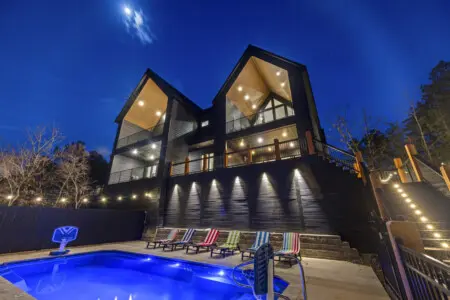 The heated pool glows blue at night while those colorful loungers wait for your crew to claim their spots.