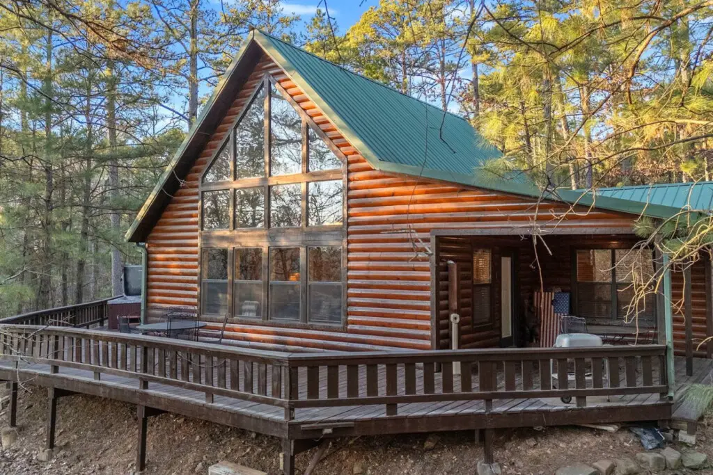 Cozy log cabin nestled in the woods with soaring cathedral ceilings and wraparound deck views.