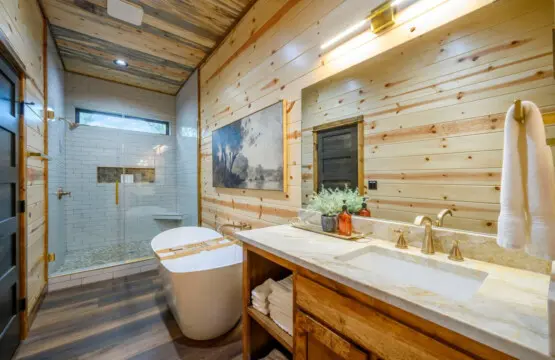 This spa-like primary bath features heated floors, a soaking tub, and a stunning walk-in shower with natural light.