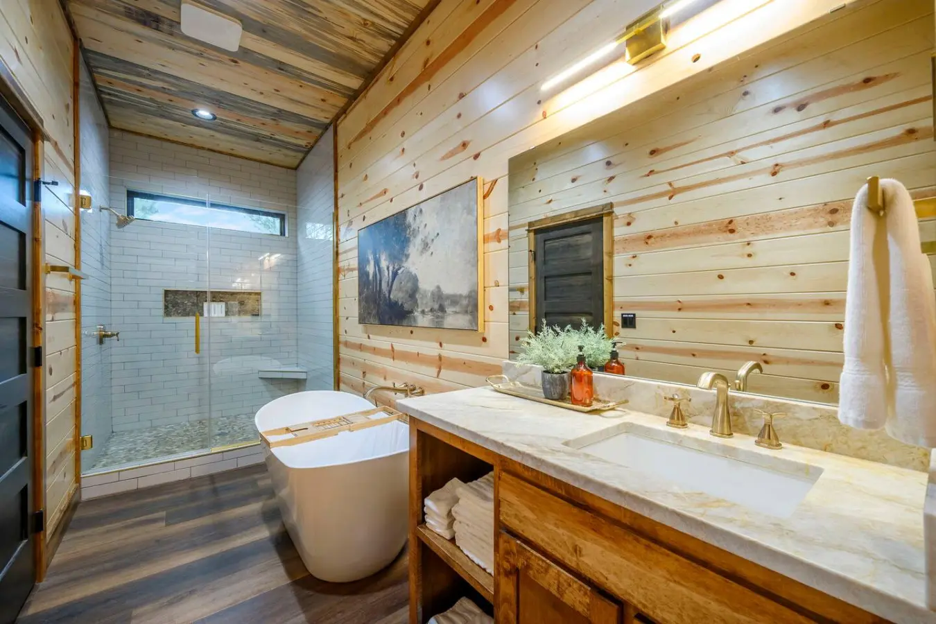 This spa-like primary bath features heated floors, a soaking tub, and a stunning walk-in shower with natural light.