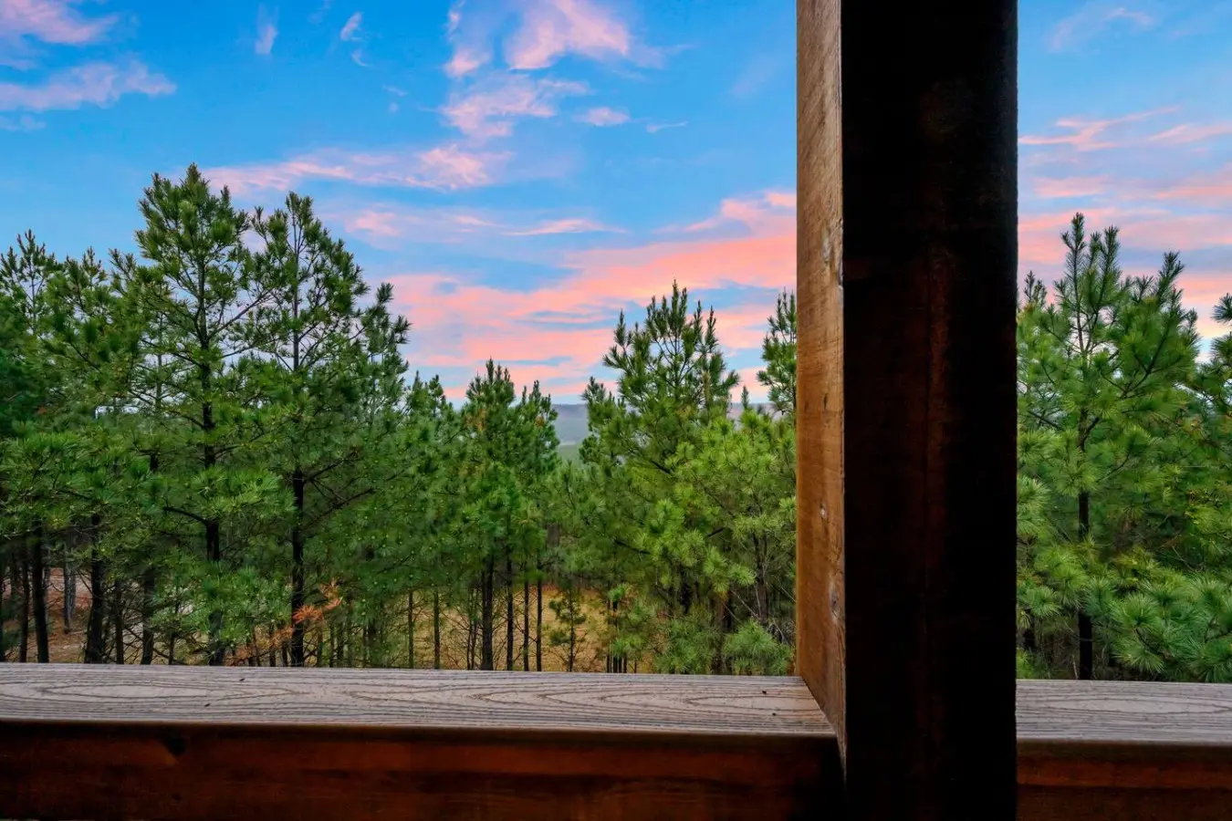 Wake up to this view from your private deck—nothing but pine trees and sky for miles.