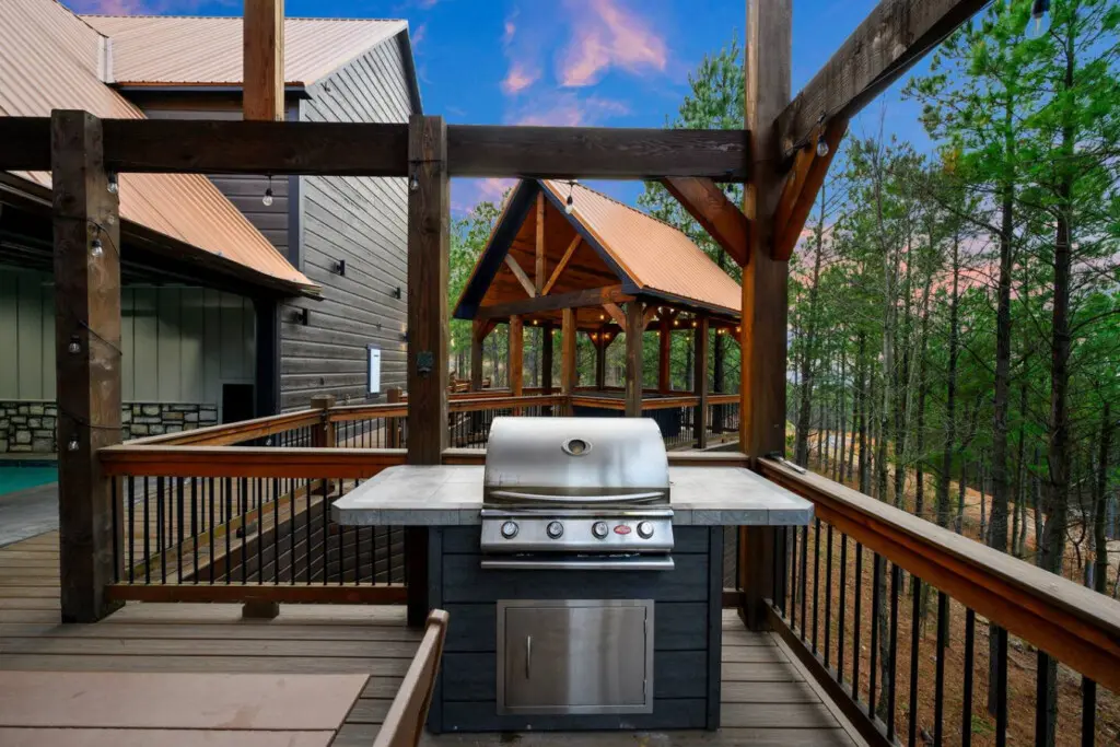 This elevated deck features a built-in grill and spectacular views of the surrounding forest and mountains.