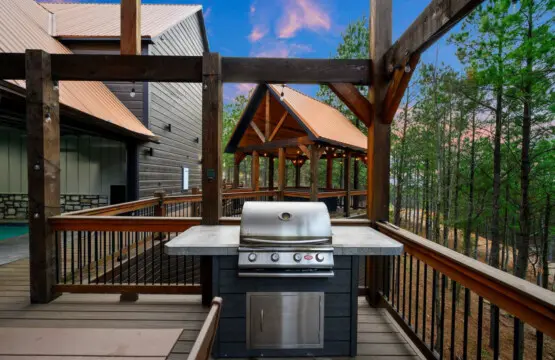 This elevated deck features a built-in grill and spectacular views of the surrounding forest and mountains.