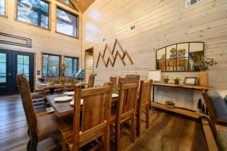 This soaring timber-framed dining hall floods with natural light and mountain views, perfect for gathering.