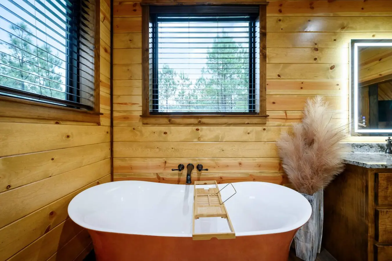 Soak in this stunning freestanding tub with forest views and natural wood everywhere you look.