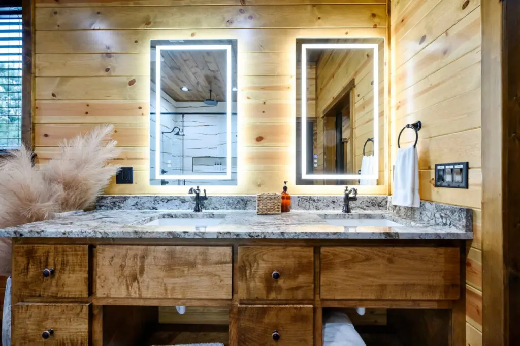 This spa-like master bath features dual vanities with heated mirrors, granite countertops, and gorgeous wood finishes throughout.