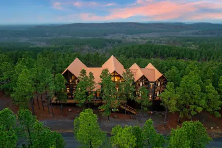 This stunning forest mansion sits nestled among towering pines with incredible views stretching for miles.