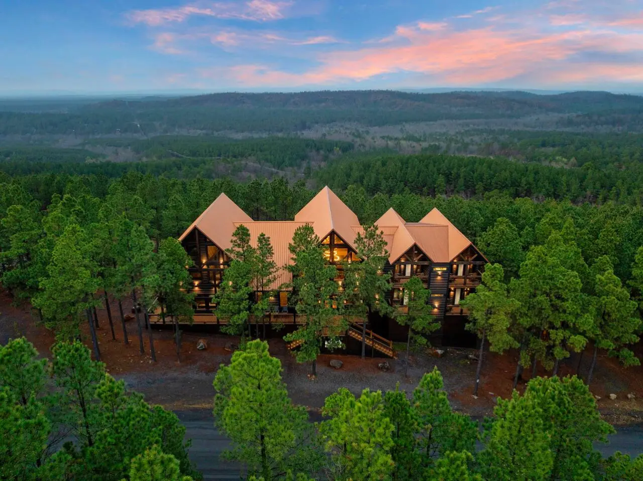 This stunning forest mansion sits nestled among towering pines with incredible views stretching for miles.