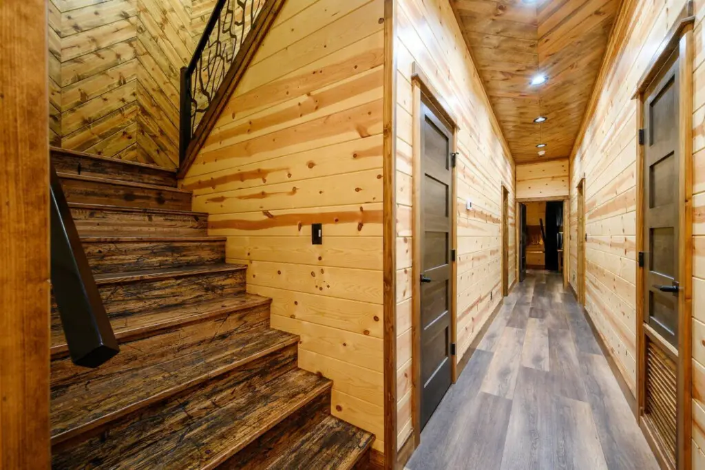 This gorgeous log cabin hallway with its soaring wood ceilings and multiple bedroom doors is built for family getaways.