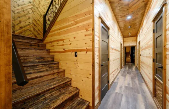 This gorgeous log cabin hallway with its soaring wood ceilings and multiple bedroom doors is built for family getaways.