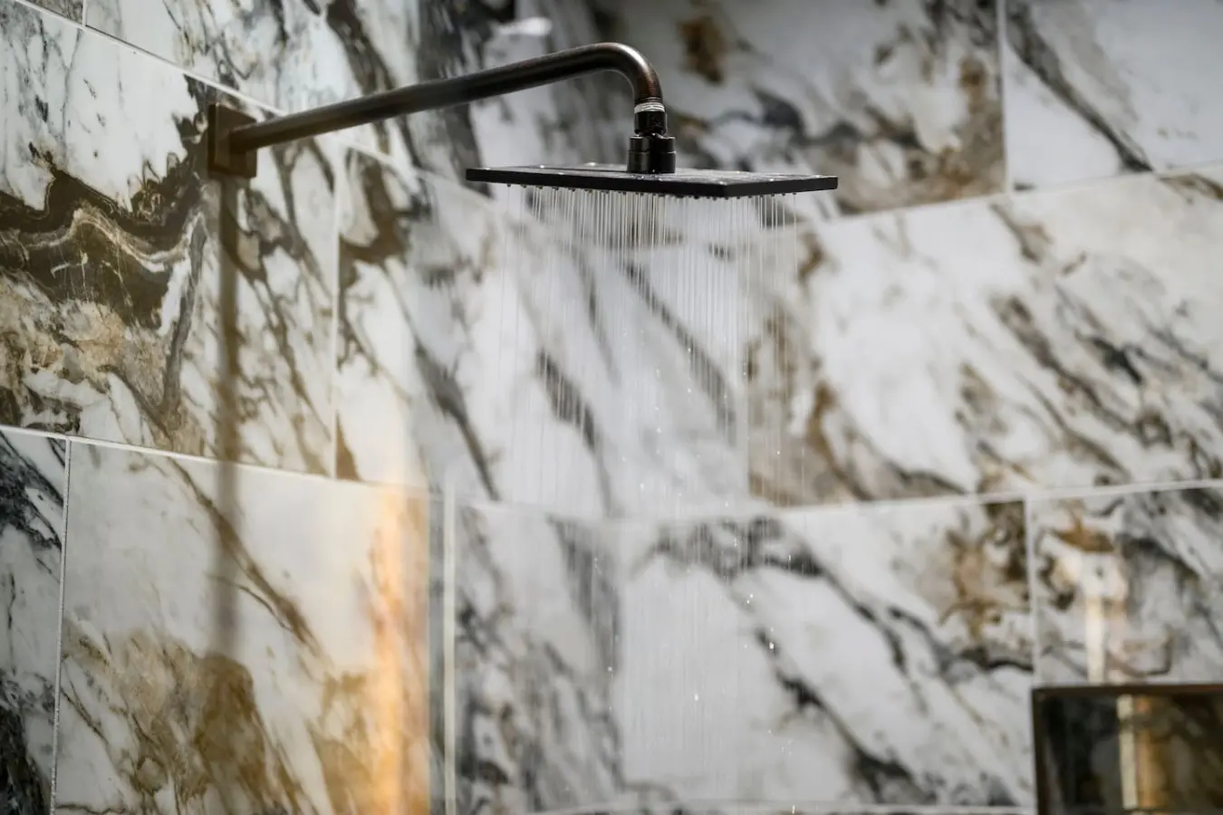 Nothing's quite like a luxe rainfall showerhead to wash away the day after exploring the marble-clad bathroom.