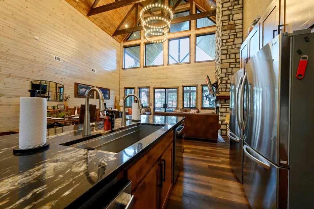 This gorgeous kitchen features soaring timber ceilings, premium stainless appliances, and tons of natural light from every angle.