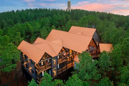 This stunning lodge sits nestled in towering pines with soaring ceilings, multiple decks, and incredible forest views.