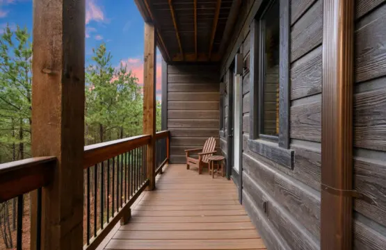 Step out onto this long covered deck and watch the sunset over the pines from your private Adirondack chair.