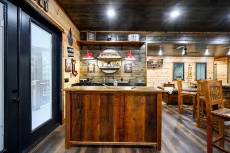 This rustic cabin bar is the perfect spot to gather with friends and enjoy the cozy wood-lined interior.