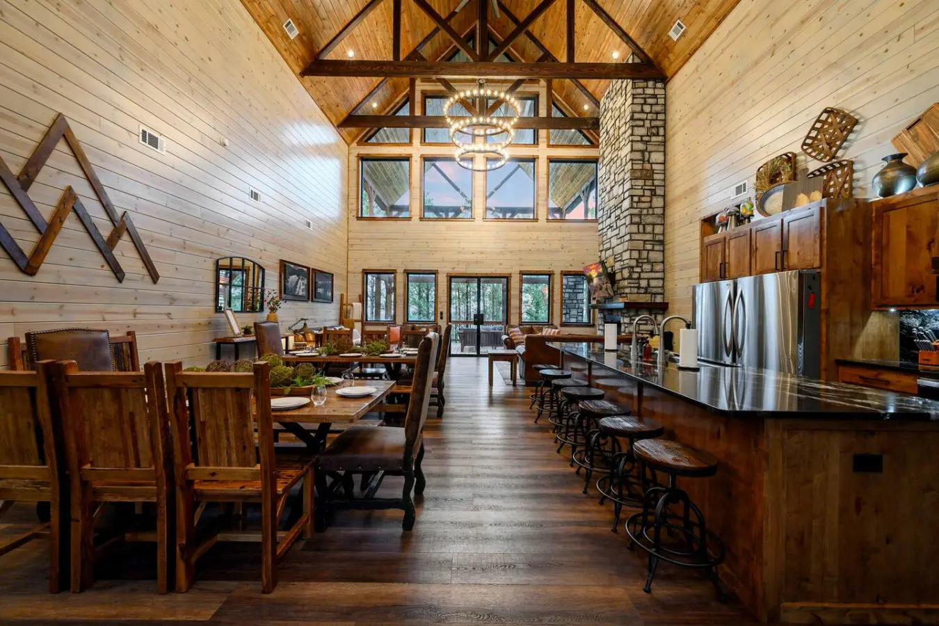 This soaring timber-frame great room with cathedral ceilings and lake views is basically the dream gathering spot for your whole crew.