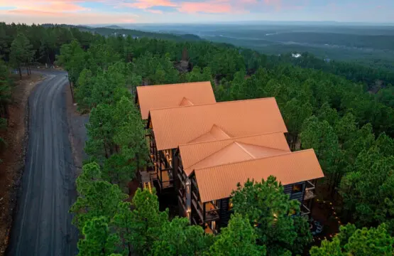 This stunning hilltop lodge sits nestled in the pines with breathtaking valley views for miles.