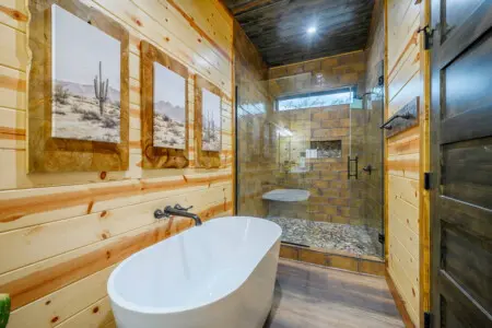 This master bath is an absolute dream with that freestanding tub, huge walk-in shower, and those gorgeous desert landscape views.