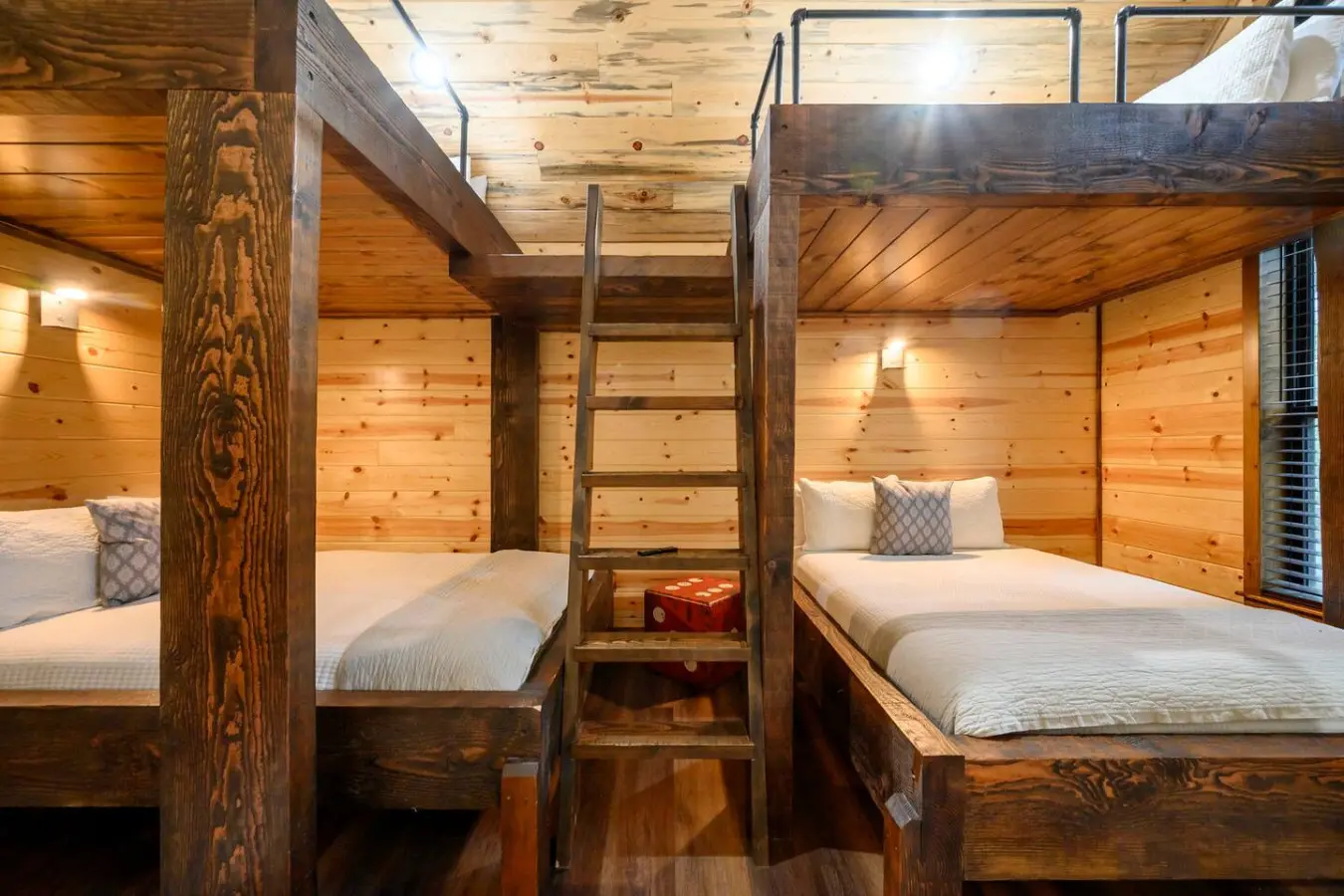 Cozy bunk room with rustic wood construction and plenty of sleeping space perfect for families or groups.