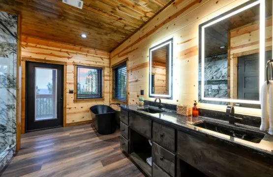 This master bath is absolutely stunning with dual vanities, a soaking tub, and those incredible mountain views from the windows.
