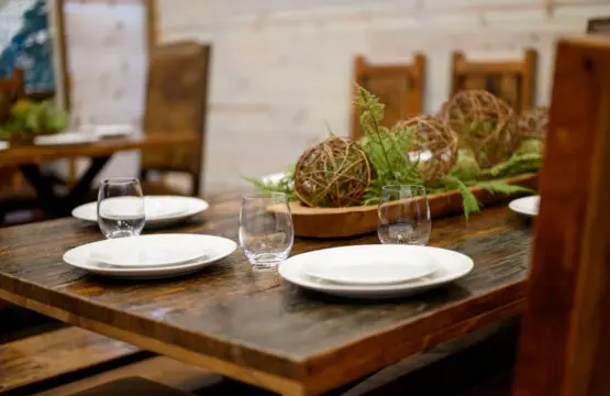 The rustic wood dining table seats guests in a warm, intimate setting with authentic charm.