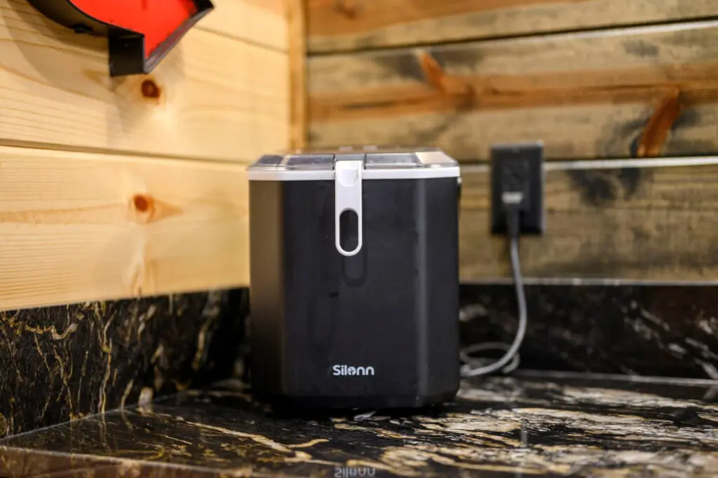 This cozy cabin setup has convenient charging stations built right into the rustic wooden shelving.