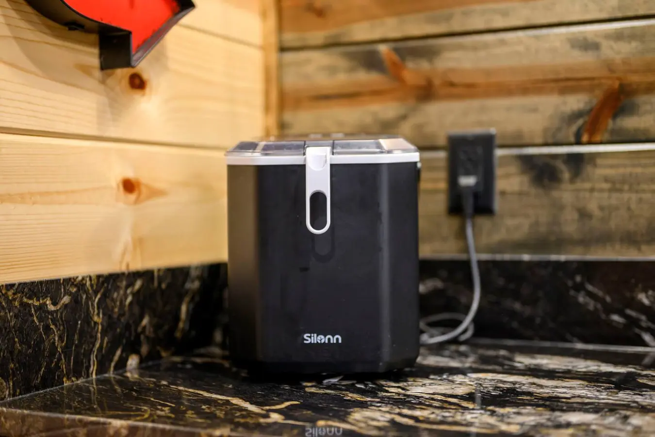 This cozy cabin setup has convenient charging stations built right into the rustic wooden shelving.