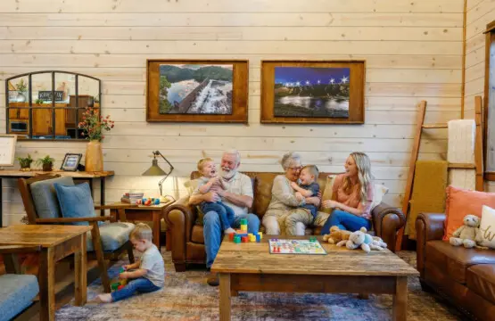 This cozy wood-paneled living room is perfect for families to relax together with plenty of comfortable seating and natural light.