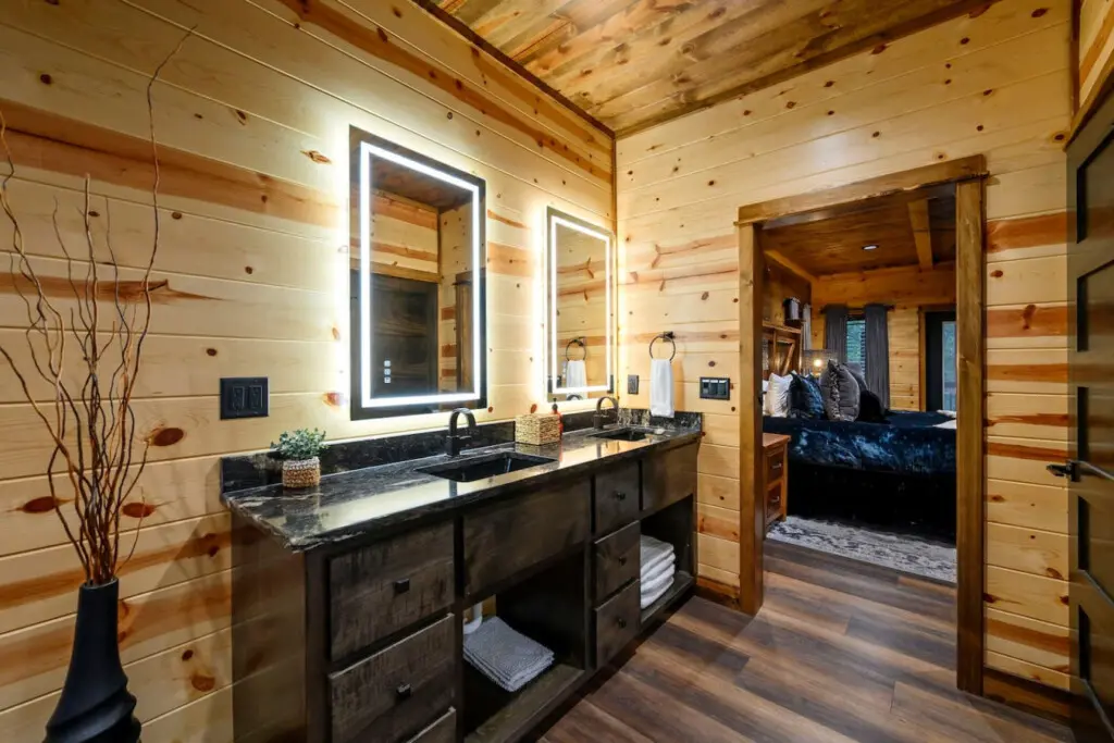 This master bath is a total showstopper with its double vanity, heated mirrors, and soaking tub overlooking the bedroom.