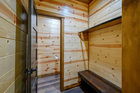 This cozy log sauna features beautiful wood construction and a rustic bench perfect for relaxing.