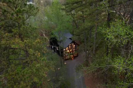 This inviting cabin deck offers peaceful views of the tranquil pond.