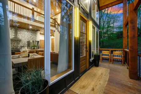 Gather around the fire pit for s'mores by the water under a starlit sky.