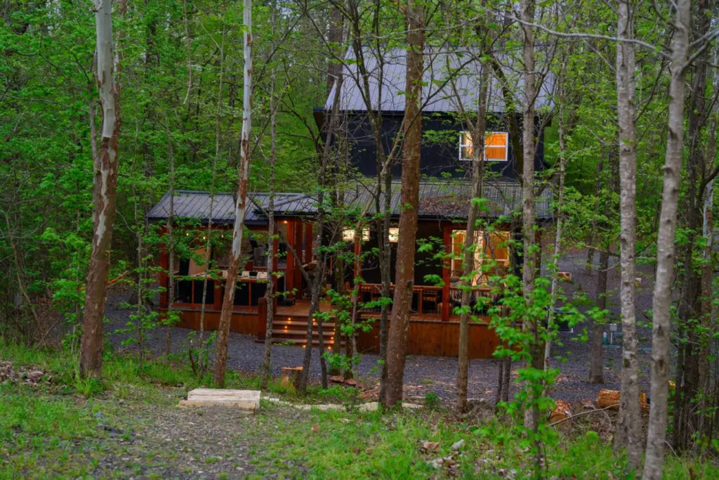 Gather around the fire pit for s'mores by the water under a starlit sky.