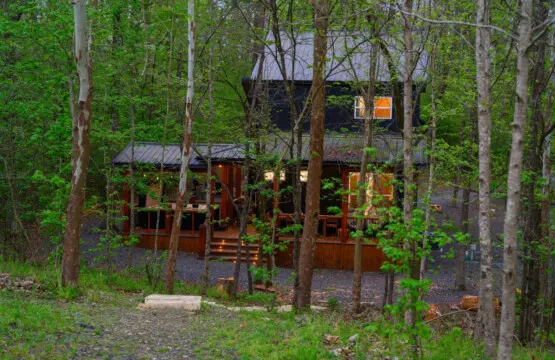 Gather around the fire pit for s'mores by the water under a starlit sky.