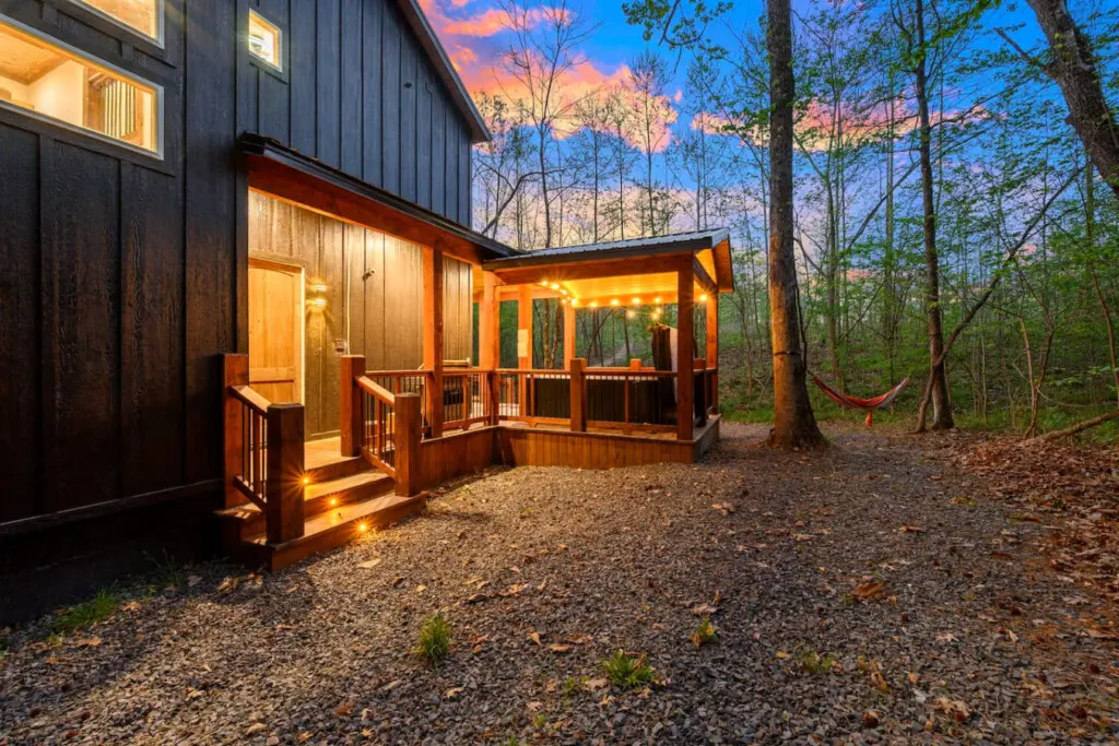 This inviting cabin deck offers peaceful views of the tranquil pond.