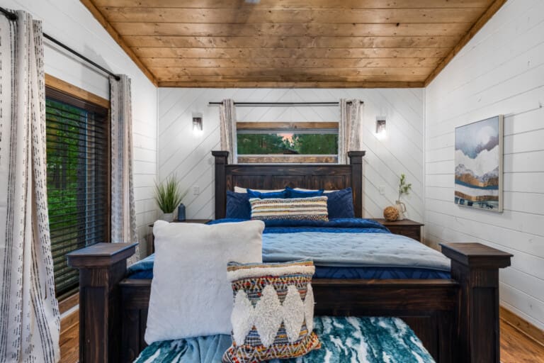 Wake up to the sound of birds chirping and the gentle rustle of leaves in our cozy cabin bedroom.