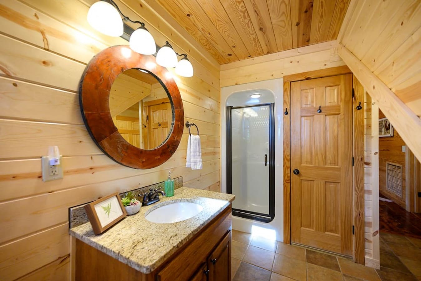Step into luxury and convenience in your bathroom oasis. A chic bathroom sink with an illuminated mirror, complete with ambient lighting, is complemented by hand soap for a refreshing cleanse, with a soft towel while admiring the tasteful accents of this