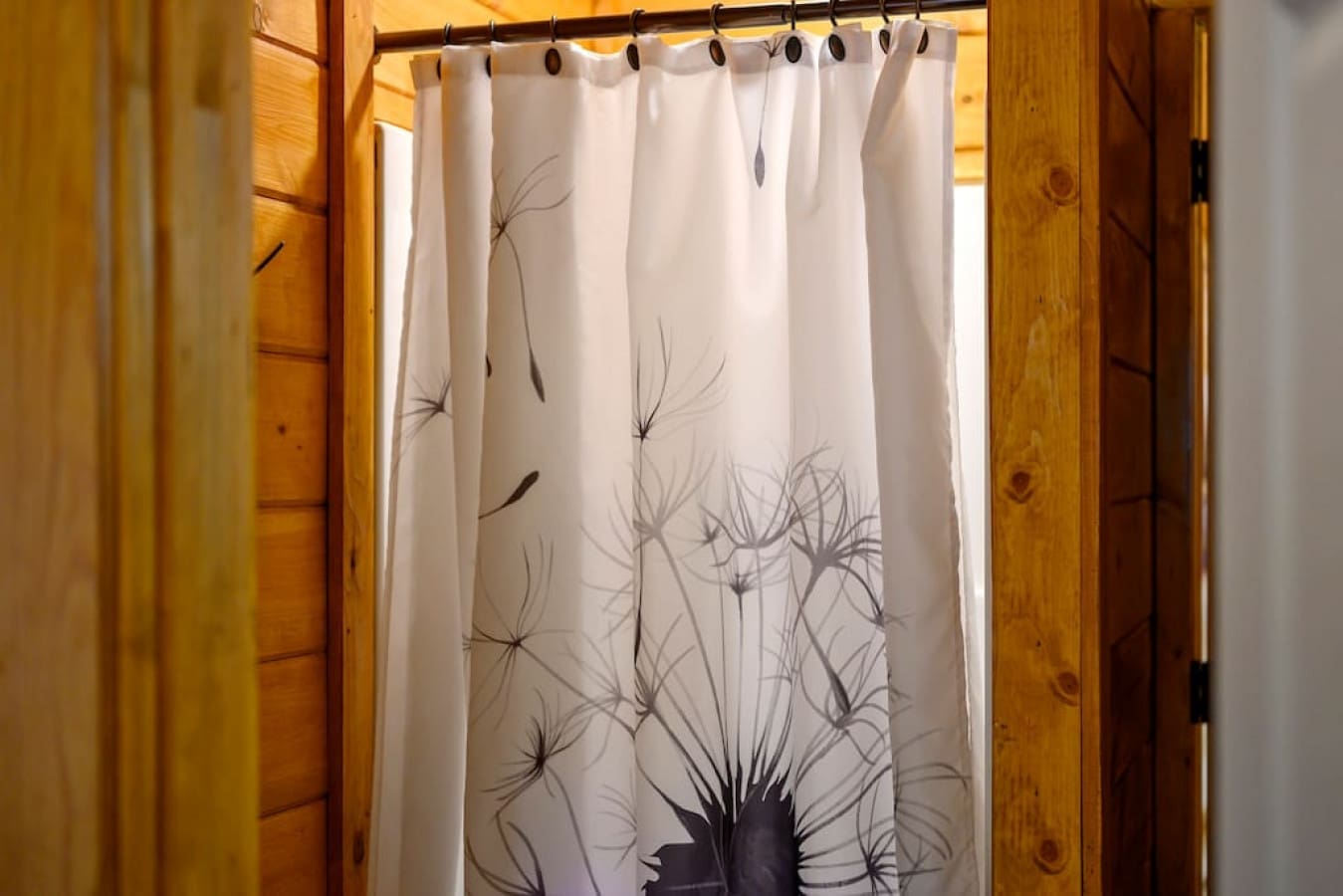 Step into a cozy bathroom retreat adorned with a chic shower curtain for privacy.