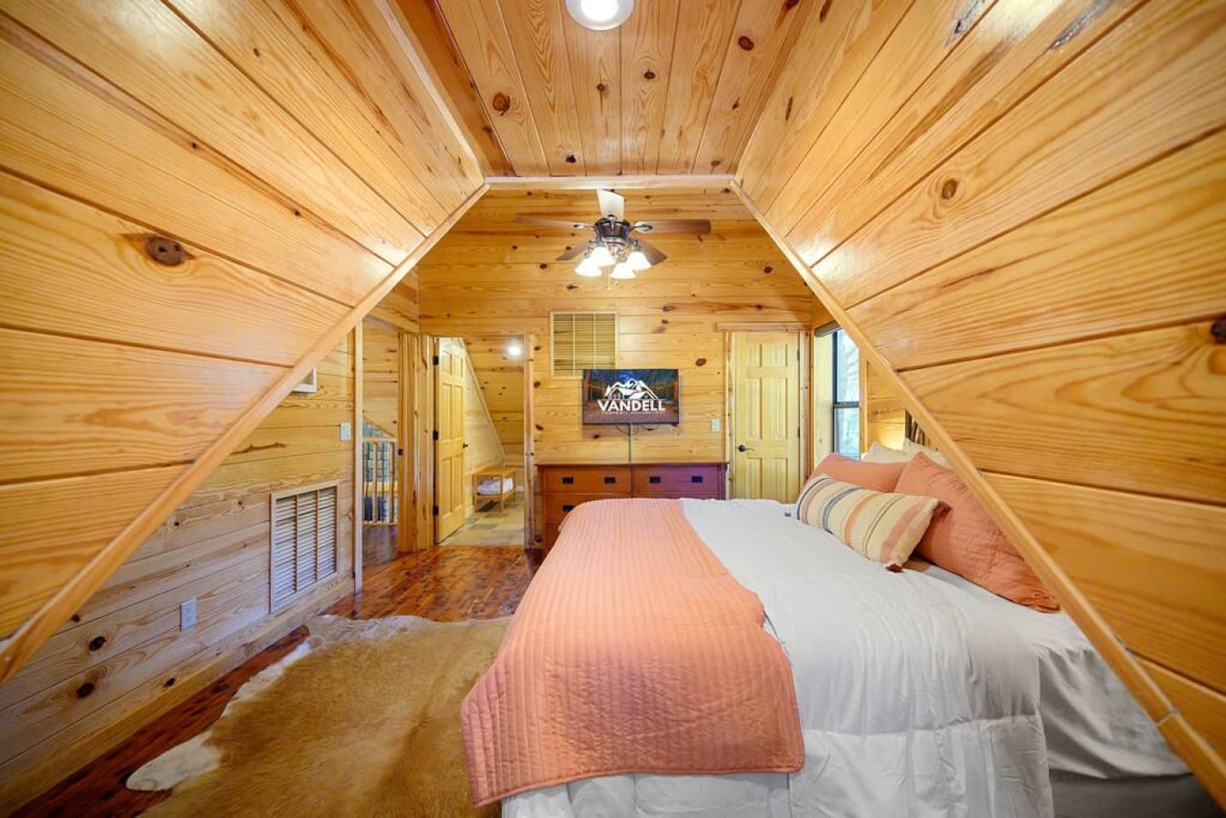 Relax in our well-appointed bedroom, featuring a comfortable bed, a small TV for entertainment, and a convenient side cabinet for your storage needs.