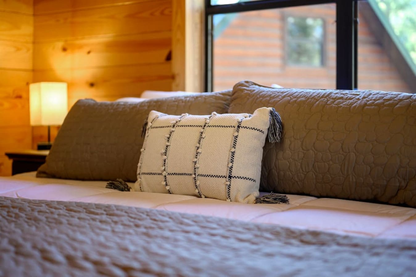 Every bed is equipped with a set of pillows and mattresses, accompanied by a convenient night lamp on its side.