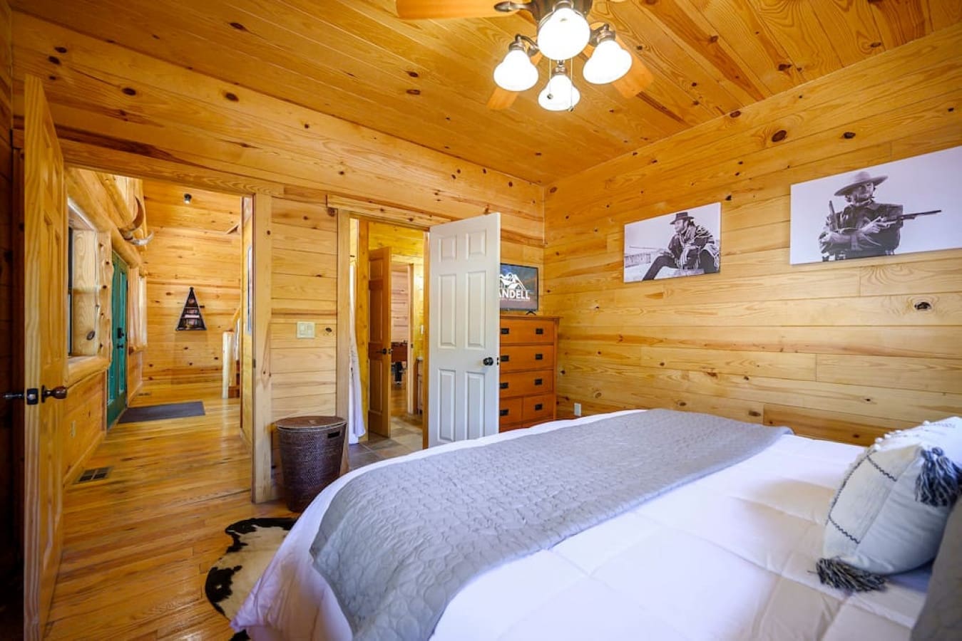 Unwind in a cozy bedroom with a bed flanked by two doors, one leading to a private bathroom. Enjoy the convenience and privacy of this well-connected and comfortable space.