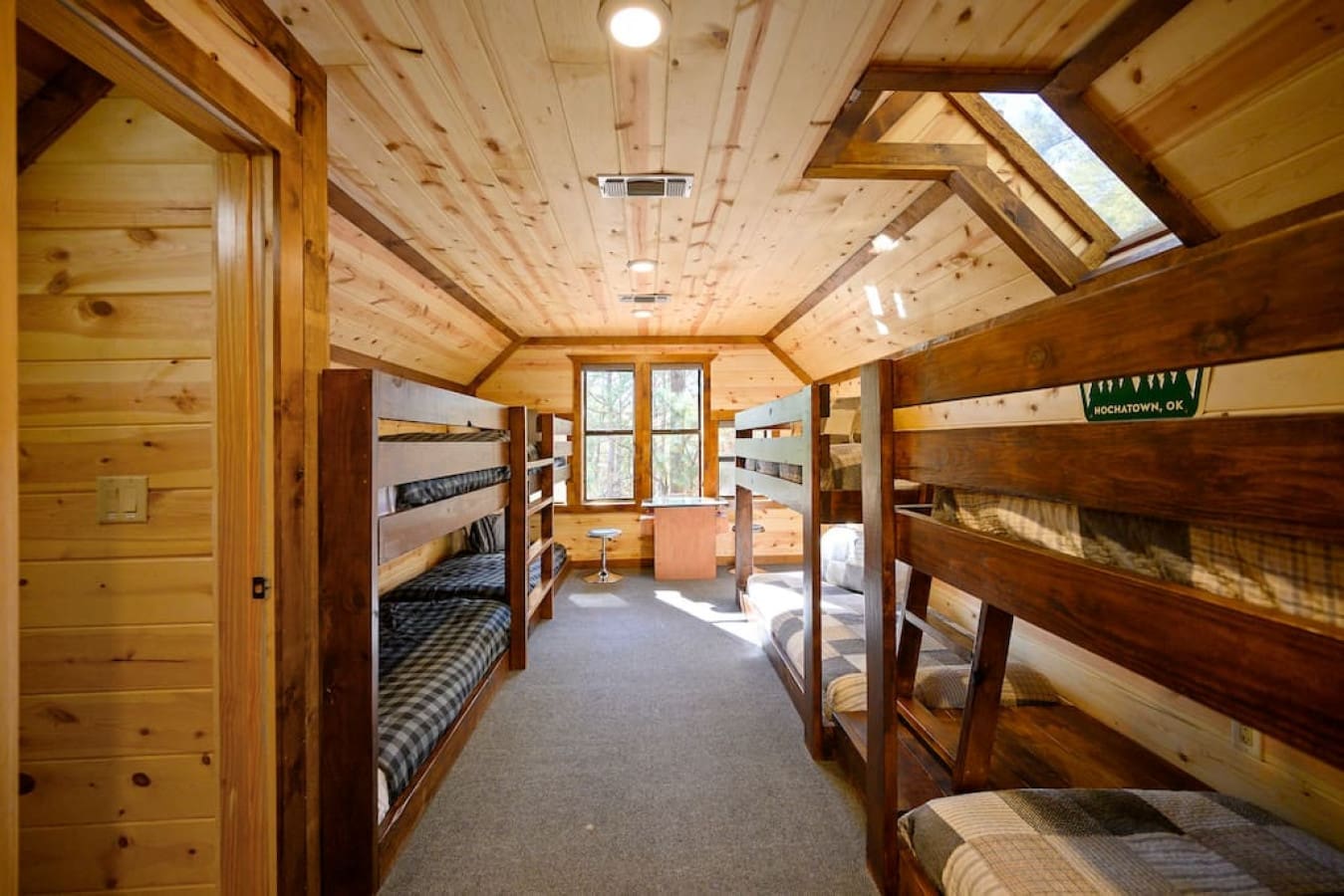 Our cabin bunkroom is the ideal spot for a group vacation. The room sleeps up to 8 people in comfortable bunk beds, and the arcade game is sure to provide plenty of fun. The decor of the room creates a cozy atmosphere.