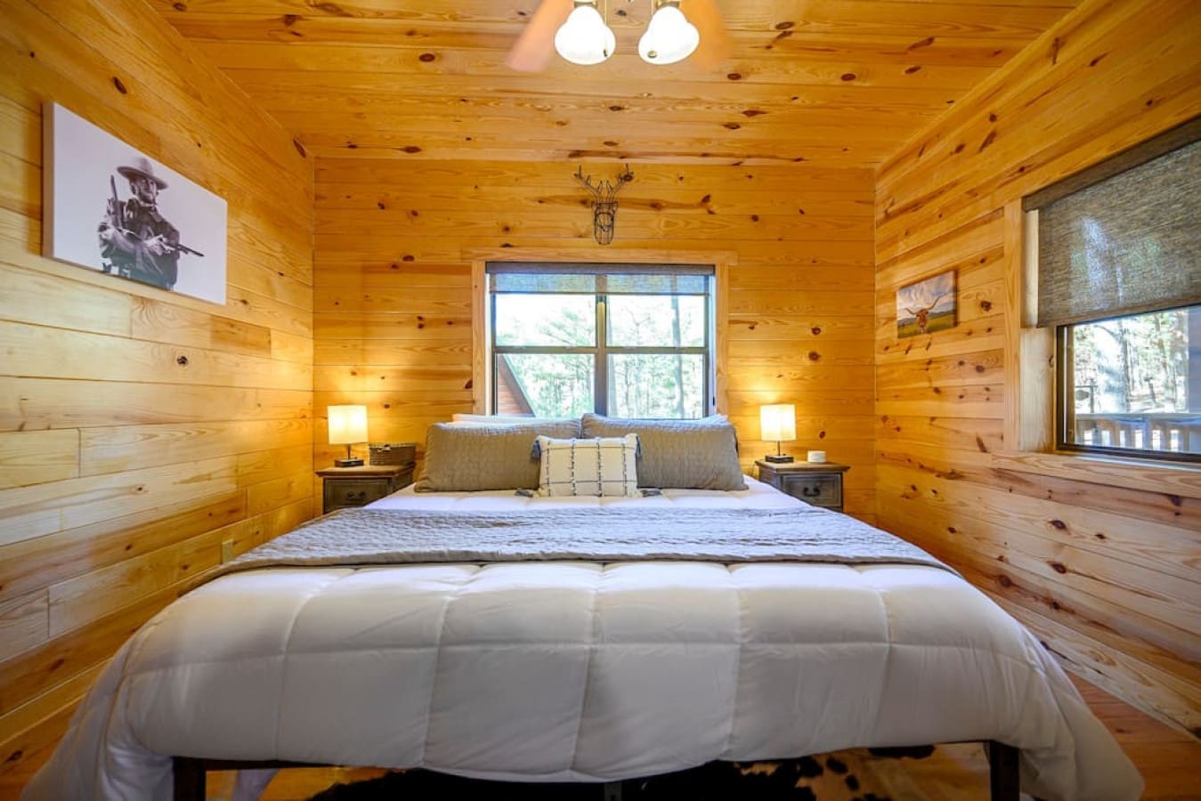 This king suite contains a plush king-sized bed with six king-sized pillows and a decorative accent pillow. The western decor adds a touch of charm and character to the room.