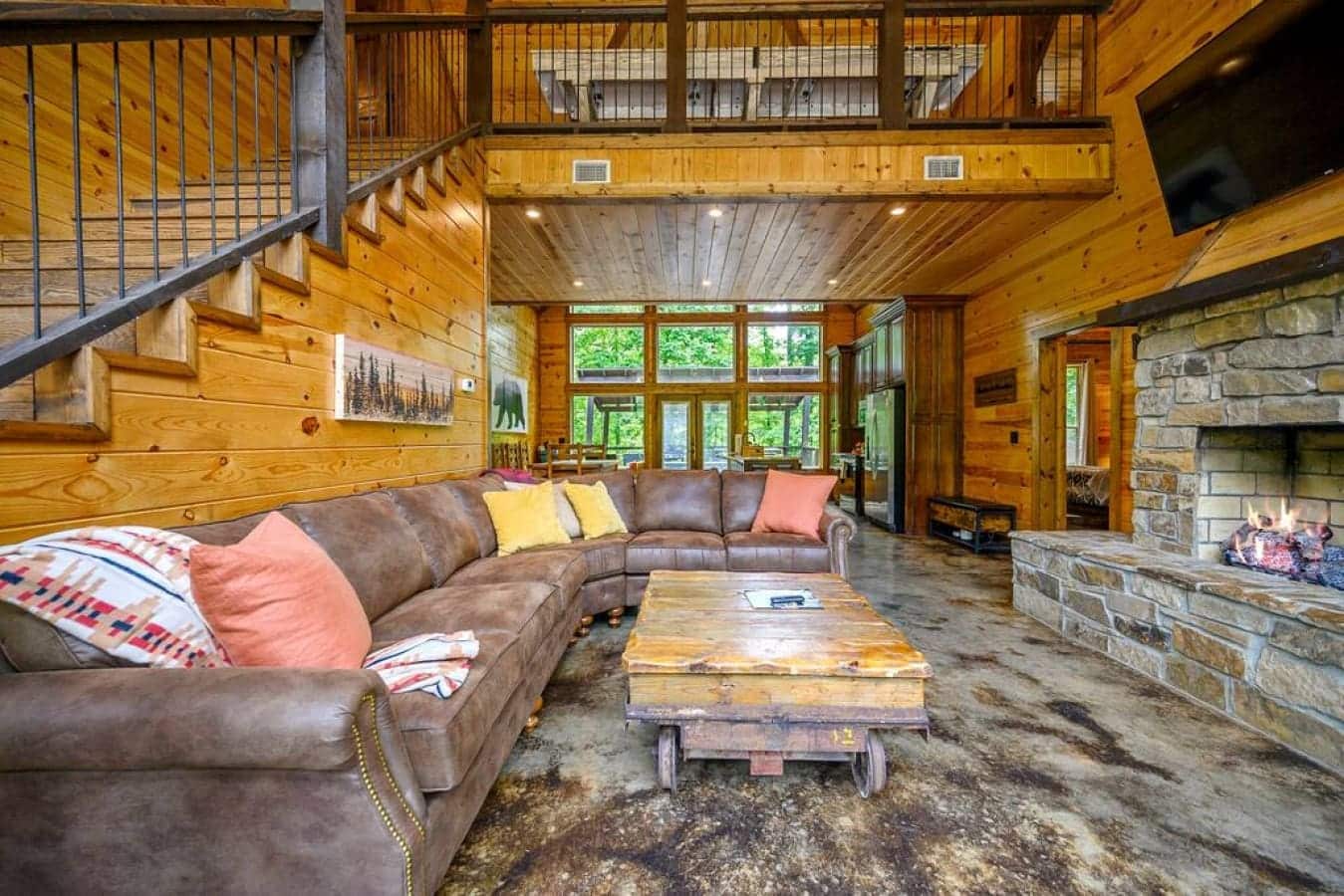 Discover the art of relaxation in this cabin sanctuary, where the warmth of the fireplace, the allure of the television, and a sumptuous chair create a trifecta of comfort.
