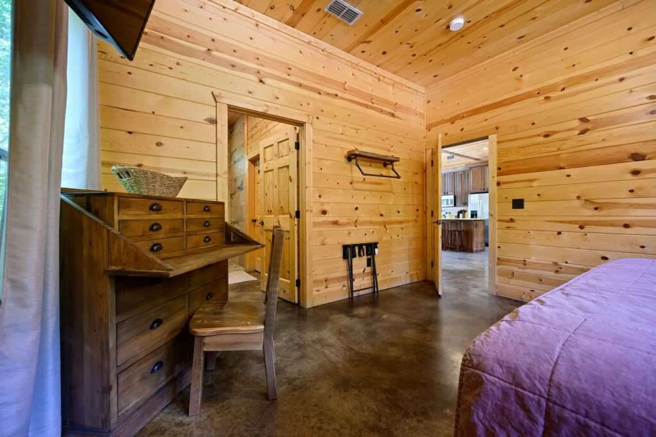 Sleep nestled in nature's embrace: cabin bedroom bliss.