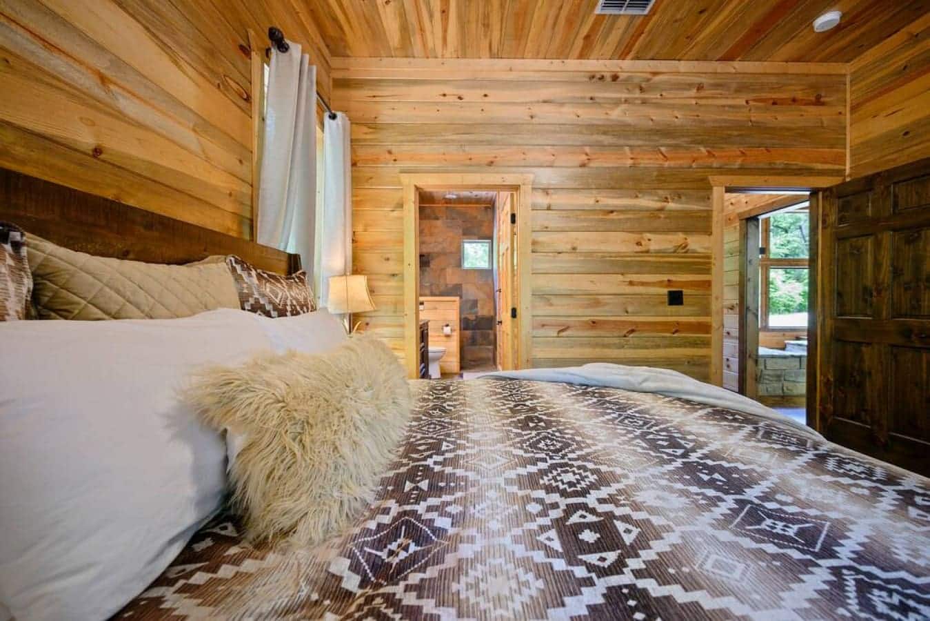 Sleep under the stars' reflection in this cabin bedroom, where rustic charm meets modern tranquility.