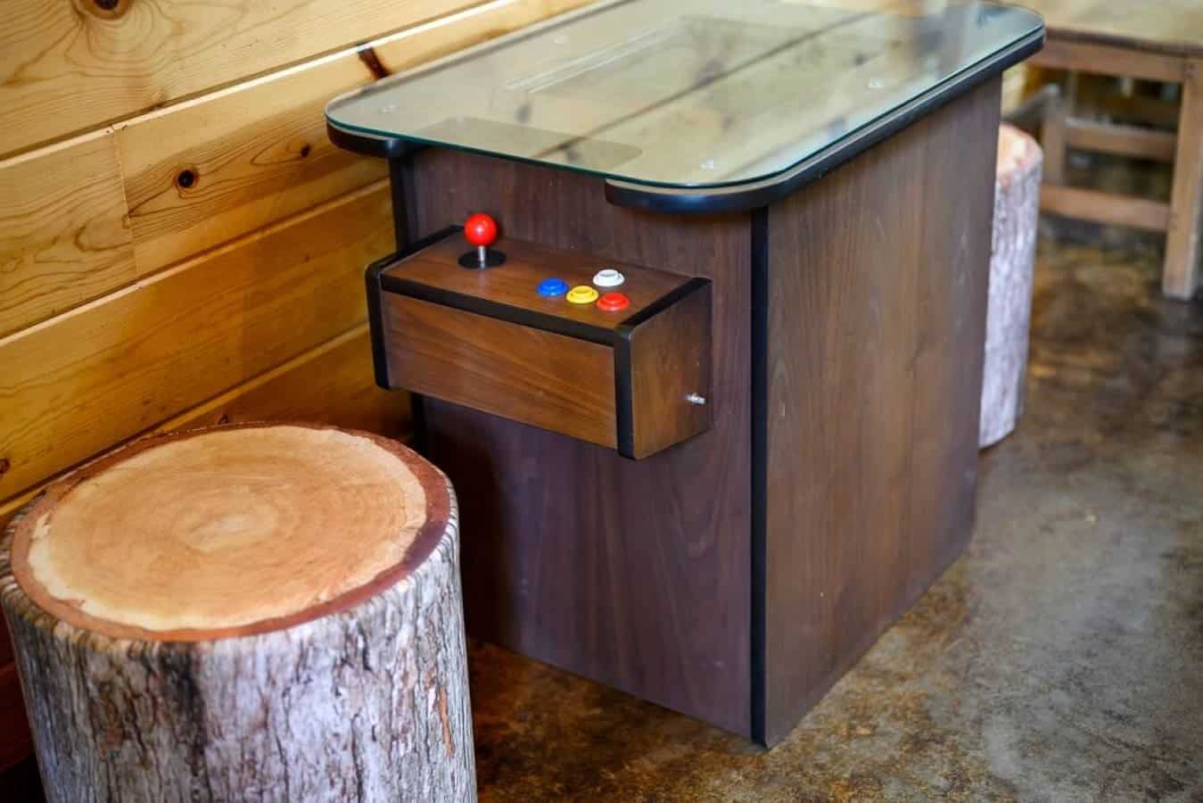 Level up your cabin retreat with a touch of nostalgia – the arcade game corner, where laughter and competition echo through the walls of this cozy escape.