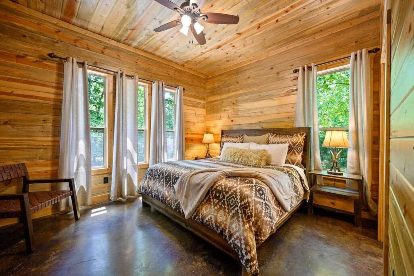 Fall asleep to the whispers of nature in this cabin bedroom, a serene sanctuary in the heart of the woods.