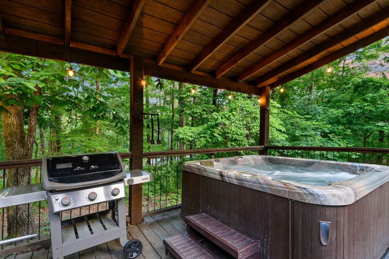 Step onto the deck of this cabin retreat, where the hot tub bubbles, the grill sizzles, and memories are made around a welcoming table.